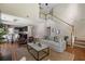 Spacious living room with hardwood floors, tall windows and a view into the kitchen and staircase at 547 Nelliefield Trl, Wando, SC 29492