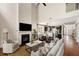 Spacious living room with fireplace, hardwood floors, and an open layout leading to the kitchen at 547 Nelliefield Trl, Wando, SC 29492