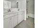 Bright bathroom with double vanity, stone tile floors, and a glass-door shower at 572 Dunswell Dr, Summerville, SC 29486