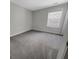 A bright bedroom featuring plush carpeting, a window, and neutral-colored walls at 572 Dunswell Dr, Summerville, SC 29486