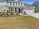 Charming two-story home with a well-manicured lawn and a welcoming front porch at 572 Dunswell Dr, Summerville, SC 29486