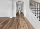 Inviting hallway with staircase featuring elegant wainscoting, beautiful wood floors, and stylish design at 572 Dunswell Dr, Summerville, SC 29486