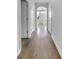 Bright hallway featuring hardwood floors and white doors with arched entryway to the front door at 572 Dunswell Dr, Summerville, SC 29486