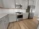 Modern kitchen with stainless steel appliances, granite countertops, and gray cabinets at 572 Dunswell Dr, Summerville, SC 29486