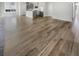 This living room features hardwood floors and an open floor plan flowing into the kitchen at 572 Dunswell Dr, Summerville, SC 29486