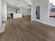 Bright, open living room flows into a modern kitchen with stainless steel appliances and beautiful hardwood floors at 572 Dunswell Dr, Summerville, SC 29486