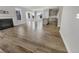 Open living space connects to a modern kitchen; the room features hardwood flooring and lots of natural light at 572 Dunswell Dr, Summerville, SC 29486