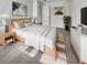 Stylishly decorated main bedroom featuring a light wood frame bed, modern art, and minimalist decor at 572 Dunswell Dr, Summerville, SC 29486