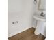 Cozy powder room with pedestal sink, lovely wood-look floors, and clean, modern design at 572 Dunswell Dr, Summerville, SC 29486