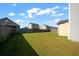 Fenced backyard featuring lush green grass and neighboring homes at 613 Ravens Wood Rd, Summerville, SC 29486
