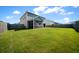 Spacious backyard featuring lush green grass and a charming screened porch at 613 Ravens Wood Rd, Summerville, SC 29486