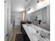 This bathroom features dual sinks, a large mirror, bright lighting, a shower, and bathtub at 613 Ravens Wood Rd, Summerville, SC 29486