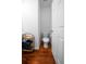 This bathroom includes a toilet, wood floors, a towel rack, and a white door leading out at 613 Ravens Wood Rd, Summerville, SC 29486