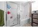 Bright bathroom featuring a glass enclosed shower, soaking tub, and tan tiled floors at 613 Ravens Wood Rd, Summerville, SC 29486