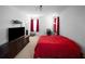 Large bedroom with a queen bed, a tv on a console, red curtains, and carpet flooring at 613 Ravens Wood Rd, Summerville, SC 29486