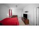 This bedroom has a queen bed, a dresser, a tv on a console, and red curtains at 613 Ravens Wood Rd, Summerville, SC 29486