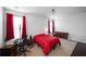 This bedroom has an office space, red curtains, two windows, and a queen sized bed at 613 Ravens Wood Rd, Summerville, SC 29486