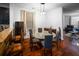 The dining area features a modern glass table, hardwood floors, and stylish lighting fixtures at 613 Ravens Wood Rd, Summerville, SC 29486