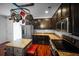Well-equipped kitchen features a pot rack, stainless steel appliances, granite countertops, and dark wood cabinets at 613 Ravens Wood Rd, Summerville, SC 29486