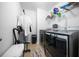 Laundry room showcasing modern washer and dryer units and organizing shelves at 613 Ravens Wood Rd, Summerville, SC 29486