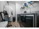 Laundry room showcasing modern washer and dryer units and organizing shelves at 613 Ravens Wood Rd, Summerville, SC 29486