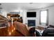 Spacious living room featuring hardwood floors, a fireplace, comfortable seating, and a view of the kitchen at 613 Ravens Wood Rd, Summerville, SC 29486