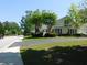Well-maintained one-story home exterior featuring green lawn and mature landscaping at 8800 Dorchester Rd # 2902, North Charleston, SC 29420