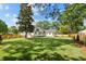 Expansive backyard featuring lush green grass, mature trees, and wood privacy fence at 924 Trowman Ln, Mount Pleasant, SC 29464