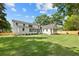Large backyard view of the home's exterior, expansive lawn, and privacy fence at 924 Trowman Ln, Mount Pleasant, SC 29464