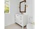 Bright bathroom with white vanity, marble countertop, and a decorative wicker mirror at 924 Trowman Ln, Mount Pleasant, SC 29464