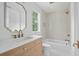Stylish bathroom with a wood vanity, white countertop, and modern gold fixtures at 924 Trowman Ln, Mount Pleasant, SC 29464