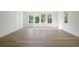 Sunlit room featuring new hardwood floors, white walls, and large windows overlooking the neighborhood at 924 Trowman Ln, Mount Pleasant, SC 29464
