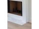 Close-up of a modern fireplace with white tile surround and decorative black iron grate at 924 Trowman Ln, Mount Pleasant, SC 29464