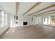 Bright, open living room with hardwood floors, fireplace, exposed beams and natural light at 924 Trowman Ln, Mount Pleasant, SC 29464