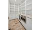 Well-organized pantry with white cabinetry, stainless steel appliances, and stone countertops at 924 Trowman Ln, Mount Pleasant, SC 29464