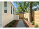 Side yard featuring a stone walkway with privacy fence and landscape at 924 Trowman Ln, Mount Pleasant, SC 29464