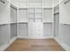 Walk-in closet featuring wooden floors and extensive shelving with built-in drawers and hanger rods at 924 Trowman Ln, Mount Pleasant, SC 29464