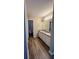Bathroom featuring a double sink vanity, modern flooring and a separate door to the toilet and tub at 9914 Levenshall Dr, Ladson, SC 29456