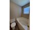 A bright bathroom featuring a soaking tub and toilet with updated finishes for a relaxing experience at 9914 Levenshall Dr, Ladson, SC 29456