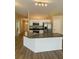 Open-concept kitchen with stainless steel appliances, a center island, and modern countertop at 9914 Levenshall Dr, Ladson, SC 29456