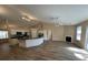 Spacious living area with an island kitchen, fireplace and sliding glass doors for backyard access at 9914 Levenshall Dr, Ladson, SC 29456