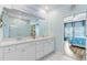 Bathroom featuring double vanity, large mirror, and view to the shower and main bedroom at 1003 Locals St, Summerville, SC 29485