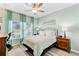 Bedroom featuring comfortable bed, ceiling fan, bedside tables, and window with light at 1003 Locals St, Summerville, SC 29485