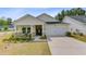 Charming single-story home boasts a manicured lawn and inviting front porch, complete with stone accents at 1003 Locals St, Summerville, SC 29485