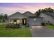 Charming single-story home boasts a manicured lawn and inviting front porch, complete with stone accents at 1003 Locals St, Summerville, SC 29485