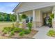 Inviting front porch features stone accents, rocking chairs, and lush landscaping, creating a warm welcome at 1003 Locals St, Summerville, SC 29485