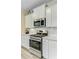 Close-up of kitchen featuring stainless steel oven, range, microwave, and sleek white cabinets at 1003 Locals St, Summerville, SC 29485