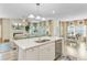 Open concept kitchen, island, and living area provides ample seating with view to the living room fireplace at 1003 Locals St, Summerville, SC 29485