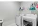 Functional laundry room featuring a white washer and dryer, wire shelving, and ample storage space at 1003 Locals St, Summerville, SC 29485