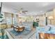Bright and open living space with a ceiling fan seamlessly connects the living room, dining area, and kitchen at 1003 Locals St, Summerville, SC 29485